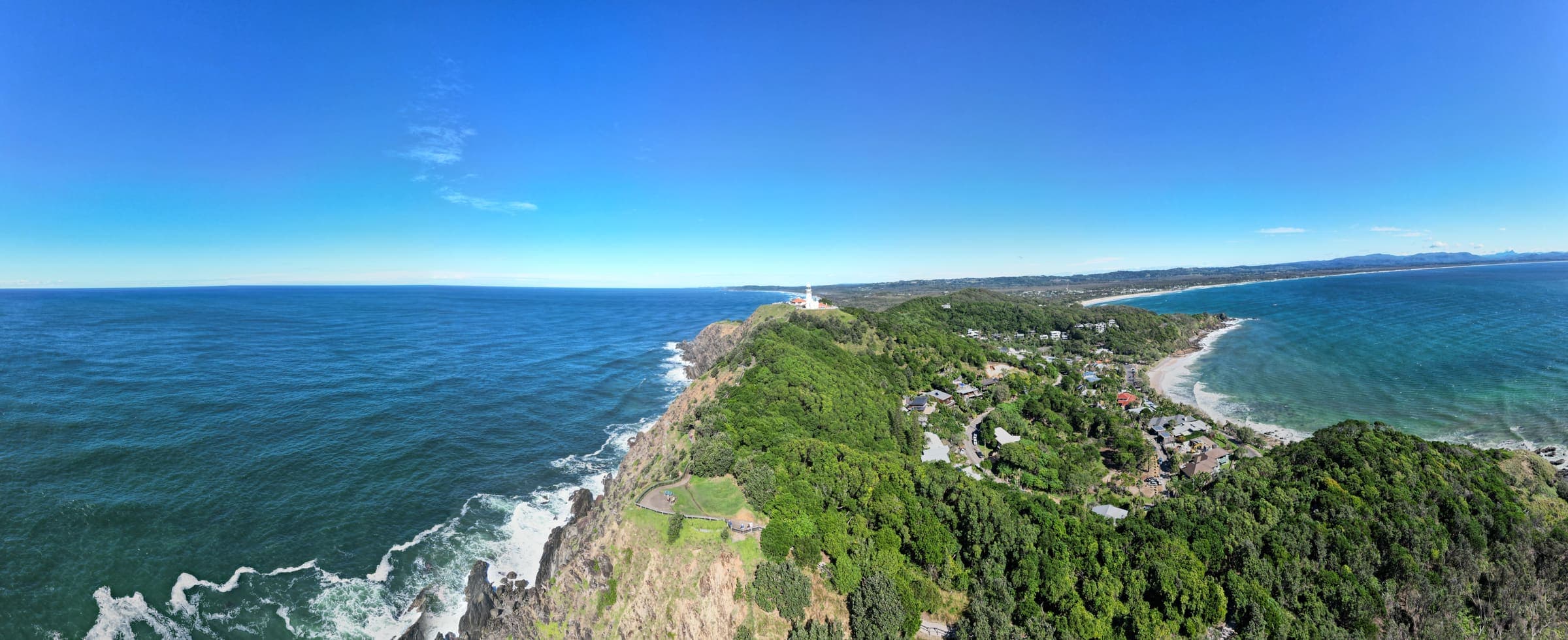 Byron Bay coastline and Cape Byron Lighthouse, viewed from above the headland