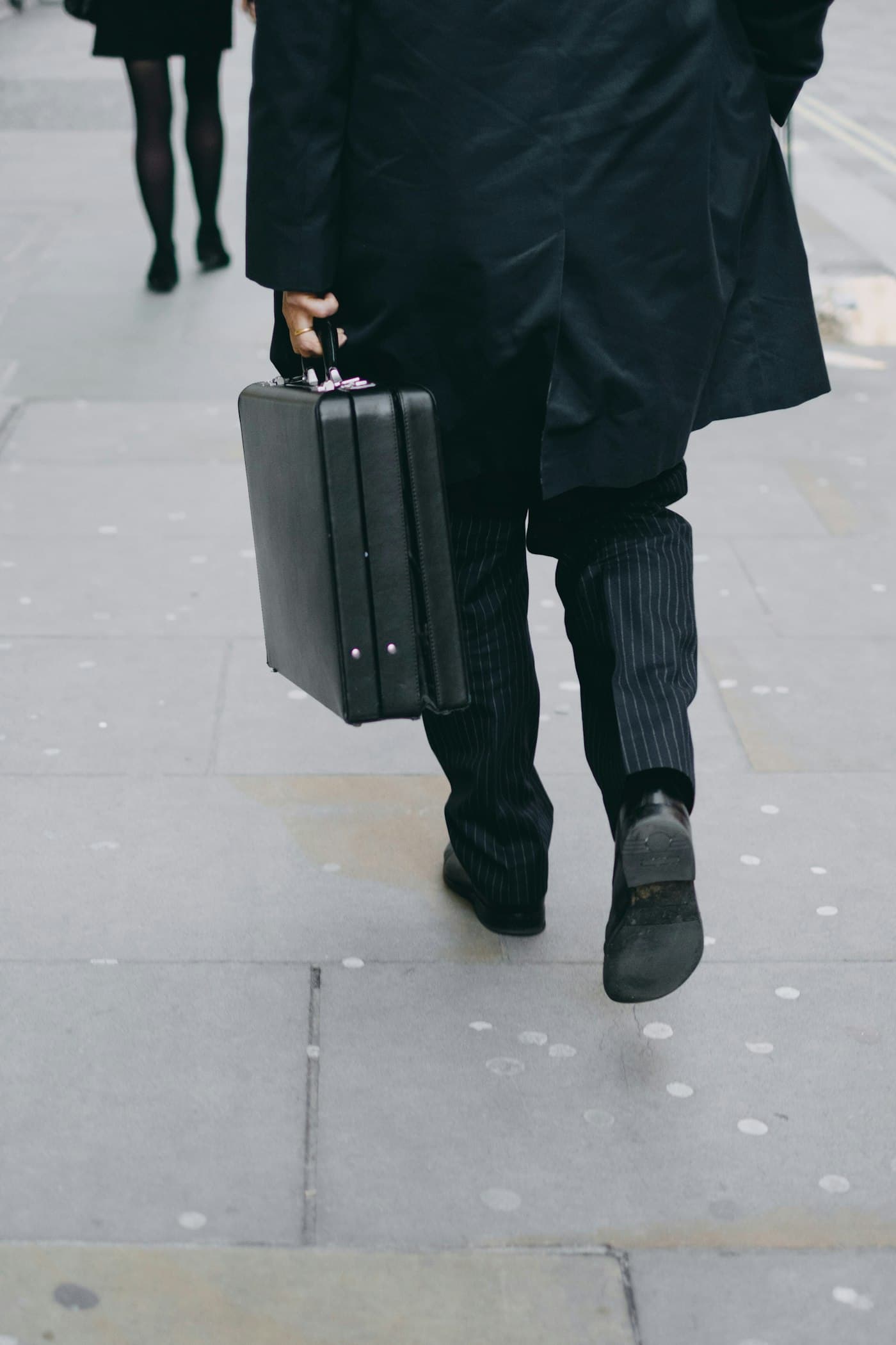 Executive walking with a briefcase in the city