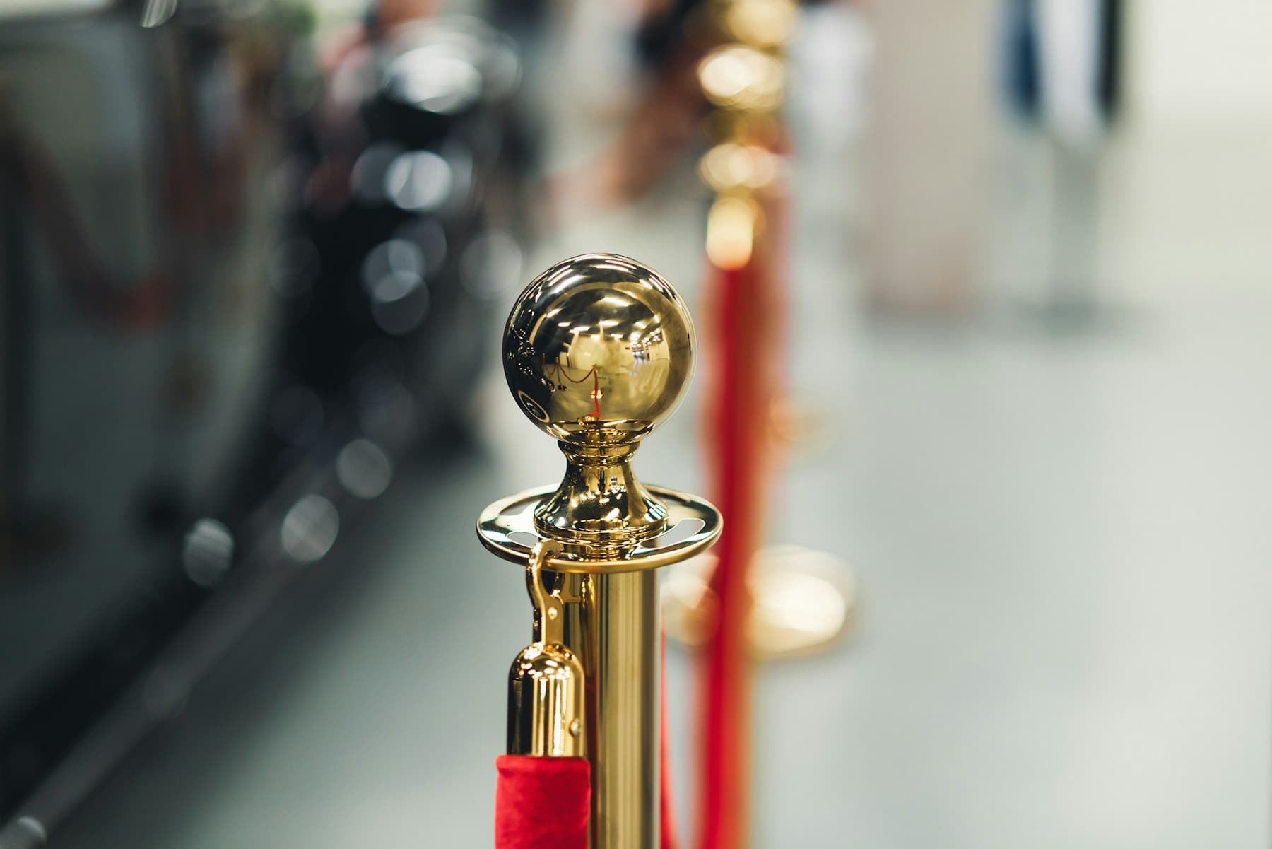 Red carpet entrance with a gold stanchion