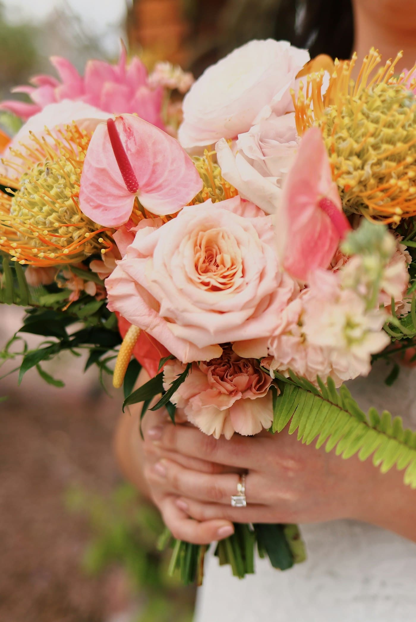Bridal bouquet held close, softly lit